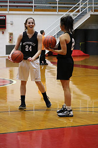 Junior Sadie Comfort and senior Madi Sherakas put in work at a basketball practice. The team won its first game at the season’s start. “Our team is doing pretty good. We need to work on handling the ball better when we are pressured,” Comfort said.
