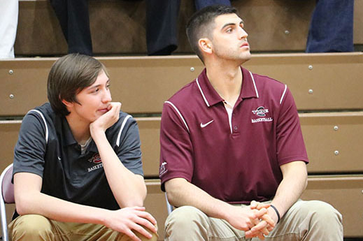 WATCH – Sitting on the sidelines during the junior varsity game against Minersville January 6,  junior Noah Nabholz and assistant coach Nick Schlitzer and observe the Crimson Tide’s defensive play. “It’s definitely cool to be back. It brings back a lot of memories from high school, especially playing at Martz Hall and being able to benefit from the great atmosphere that the place provides. I feel like I’ve never left,” Schlitzer said. 
