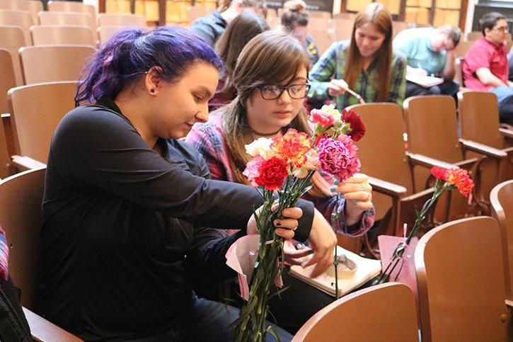 Juniors Tahlia Estep and Gabriella Frick look at the Valentines grams they received. After receiving the flowers, they showed them off to each other. I received 14 Valentines grams this year. I really like that our school does this, Frick said. 