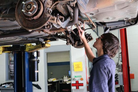 OBSERVE – Checking out the underside of a Subaru Outback, senior Dakota Butler tightens a nut on an extension of the engine. Butler had to take a car engine totally apart and put it back together for one of his project grades. “I decided to go to STC because I wanted to learn about mechanics and I like to work on cars. I specifically like to work on engines,” Butler said. “It’s the hands-on experience that really helps.”