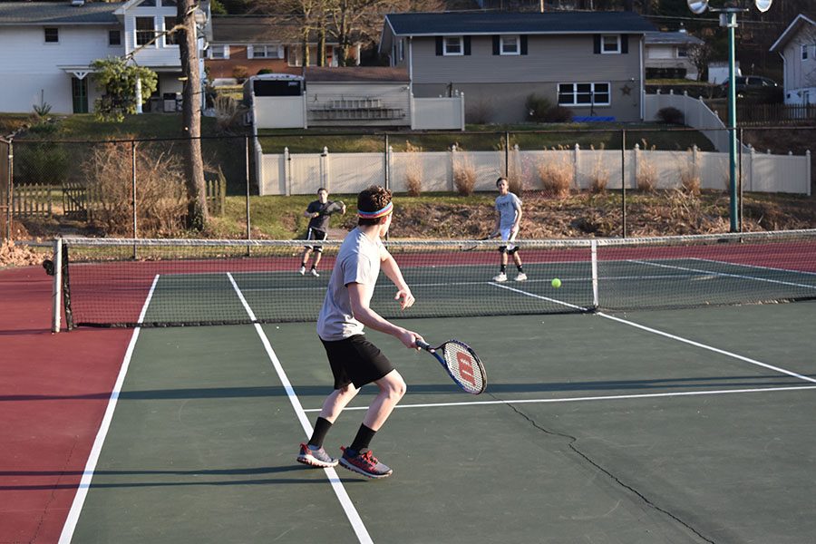 Boys’ tennis team members practice for their matches. They lost all of their matches so far but hope to turn things around. “Our team could work on improving our defense, which I think is where we struggle the most,” junior Jamie McCabe said.

