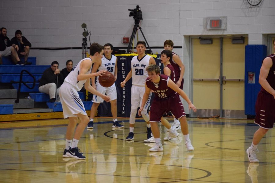 Aiden Stanton stands in front of Blue Mountain player trying to block the ball. He moved quickly to stop him from getting the shot. “My brother and I are a lot harder on each other than our other teammates.”