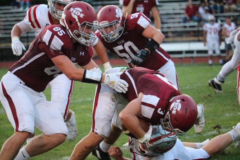 Junior+Bobby+Walchak+is+tackled+by+opposing+players.+The+Crimson+Tide+ended+the+game+with+a+victory.++Senior+Clayton+Demcher+said%2C+%E2%80%9CBeing+in+%5Bthe+student+section+in%5D+front+of+the+football+players+and+supporting+my+boys+every+Friday+is+always+a+blast.%E2%80%9D