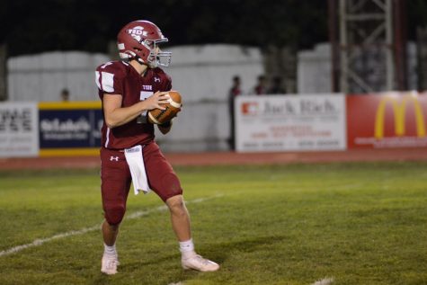 Senior Damon Yost is scanning the field looking for a receiver to throw the football to. 