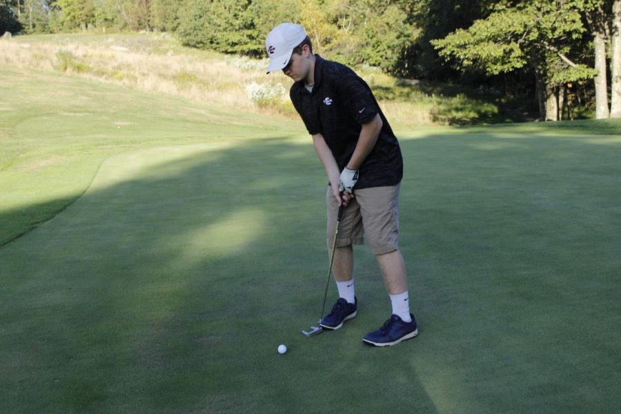Junior David Troutman is preparing to hit the ball. He wanted to make it into the hole to help his team. “I want to focus and try my best on all 18 holes,” said Troutman’s teammate, Dominick Chiccini. 
