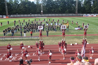 Cheerleaders are performing during the District-Wide Pep Rally. This was Pottsvilles  first outdoor Pep rally. “My favorite cheer at the pep rally was Dig-a-Hole. It is fun to do the cheers with my friends,” said 6th grade Ella Selinko   [watching from the stands]. 
