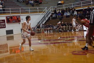 Senior Mason Barnes looks down the court for a teammate to pass the ball to. Barnes has been playing basketball for PAHS all four years of high school. “I plan on playing basketball in college. It has been a goal of mine since I was young,” said Barnes.