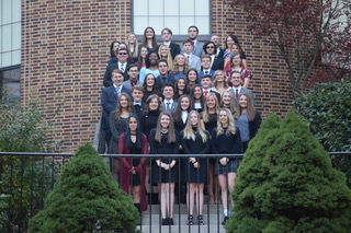 National Honor Society Inductees stand on the courtyard stairs after their induction. 36 juniors and seniors were admitted into the society that honors academic excellence. Inductee junior Jake Montgomery said, “Always put your best effort into your work while not overdoing your limits.”