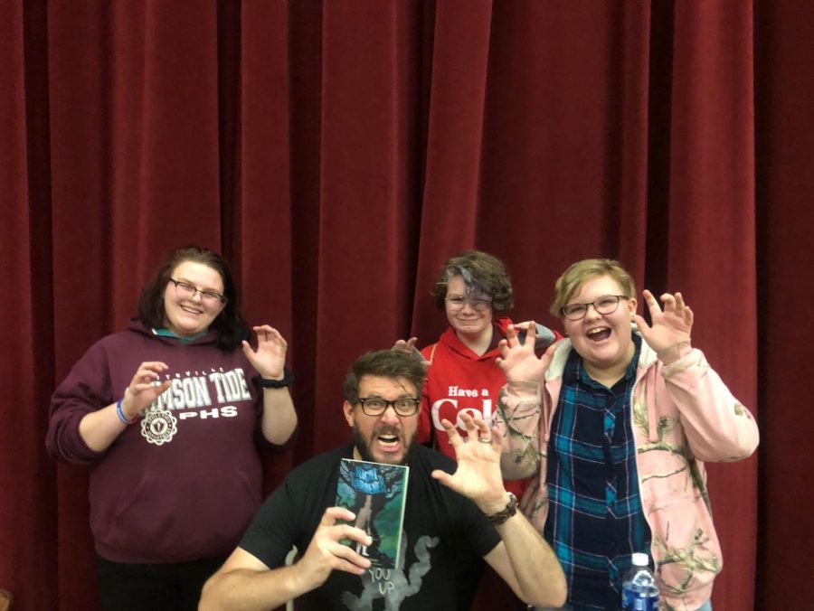 POSE - 8th graders Madison Auman, Jaden Ebert, and Catherine Lubinsky pose with author Jonathan Auxier at Teen Library Day at Kutztown University.