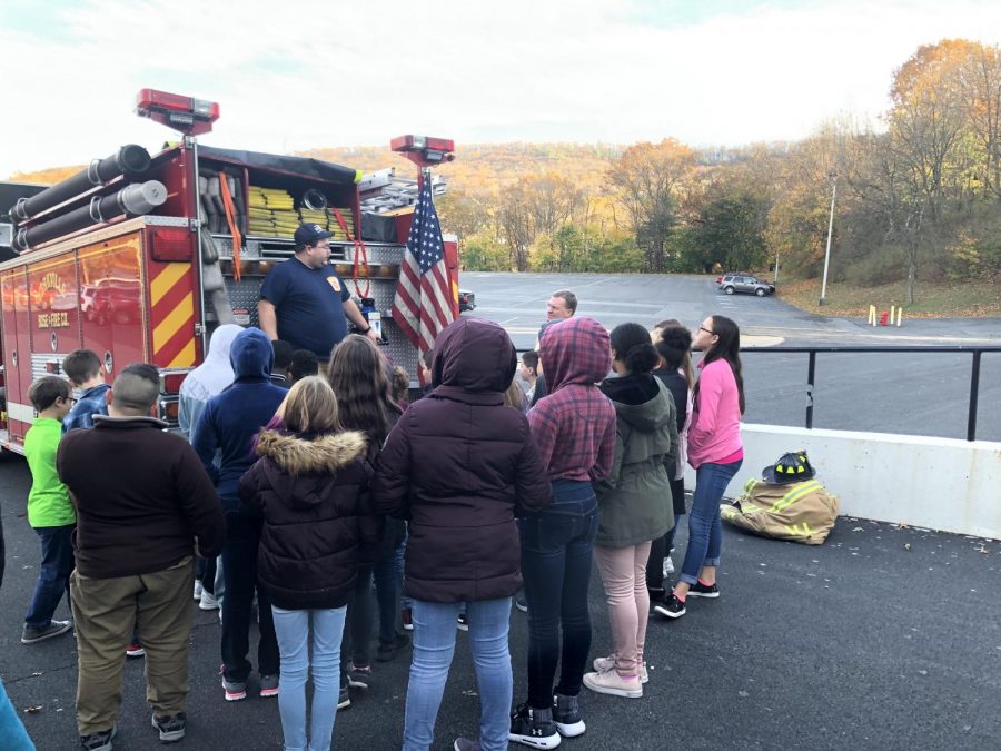 TOUR - Students at the Schuylkill Achieve after school program learn about fire safety and are given a firetruck tour by Lt. Dan Kleeman and Dr. Zwiebel from Yorkville Hose Company.