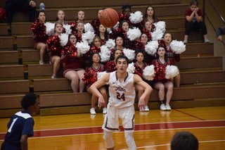 Senior Matt Salata passes a ball to his teammate. The Crimson Tide lost this game with the final score of 70-49. Salata said, “We’re not the biggest team so we need to work on getting big and boxing out to limit offensive rebounds for the other team.”   