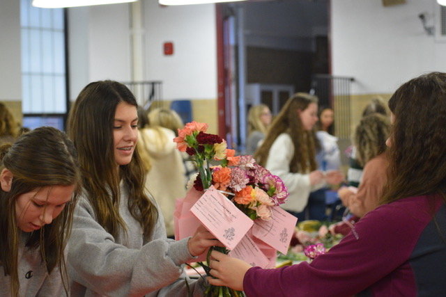 Freshmen Maya Golden, Kyler Bowers and Alex Blum organize the AID flowers to prepare for the distribution on Valentine’s Day. Students at PAHS purchased  the flowers throughout the month of January. “The AID valentines take a lot of organizing and help from both the members and Ms. Coleman,” Bowers said. 