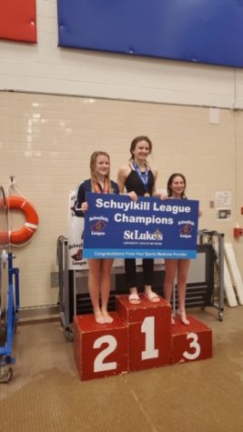 Juniors Greta Snukis and Emma Smith stand on the podium after the Schuylkill League Diving Championships. Snukis placed first in diving while Smith placed third. Snukis said, ”My hard work and countless hours of nonstop diving paid off. I was super happy to have clean dives throughout the meet.” 