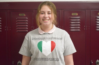 Sophomore Kaylee Becker wears her Spanish t-shirt on Thursday March 5, 2020. Students in Ms. Lloren Reicherts Spanish classes were given the chance to wear Spanish shirts for bonus points. While some students customized their t-shirts, others simply attached a flag. I printed out a Spanish flag for Foreign Language Week but it got crumbled, so I printed out a smaller one to attach to my shirt, said junior Naomi Brode.
