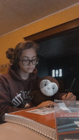 Sophomore Trinity Reedy shows off her coloring skills accompanied by her stuffed sloth, Barbecue Sauce. Trinity said,