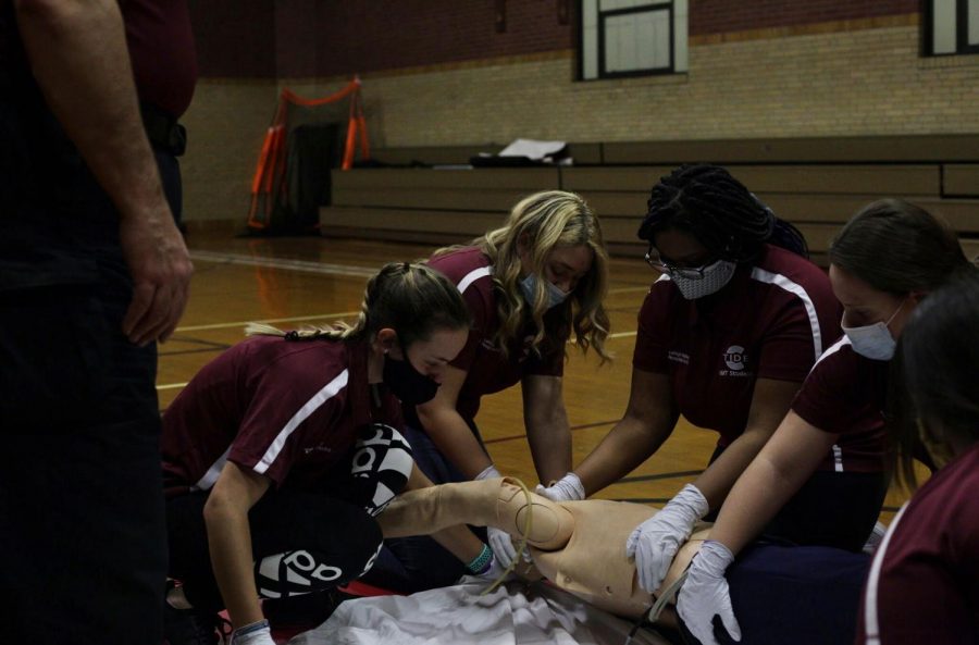Students+in+the+EMT+class+do+hands-on+work+such+as+performing+CPR+on+a+dummy.+The+class+can+make+someone+certified+in+CPR+and+can+also+lead+to+a+future+in+the+medical+field.+Senior+Jamilah+Philip-Johnson+said%2C+%E2%80%9CBeing+in+the+EMT+course+is+different+from+any+class+I%E2%80%99ve+had+before.+The+beginning+of+the+year+was+mainly+learning+from+book%2C+which+was+important+since+we+need+to+know+specific+terms.+Now+that+we+are+nearing+the+end+of+the+year%2C+we+have+way+more+hands-on+learning.+We+also+have+after+school+sessions+that+show+us+exactly+what+to+do+for+various+situations.+Unlike+other+teachers+Mr.Moran+is+able+to+show+us+exactly+how+he+works+as+an+emergency+medical+technician%E2%80%9D%0A