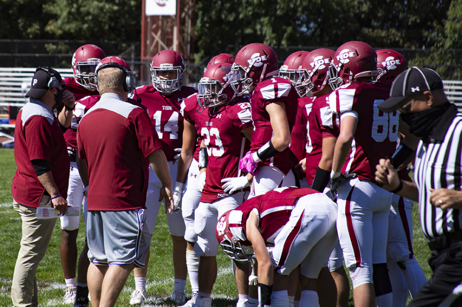 Tide coaches talk to players on the sideline during a game in September of 2020. 