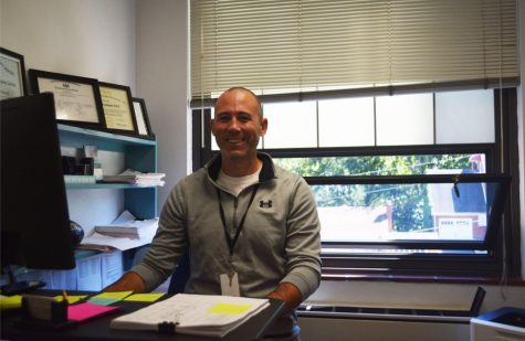 Mr. John Gradwell sits at his desk with a happy expression on his face. He can be seen throughout the day in his office or throughout PAHS.