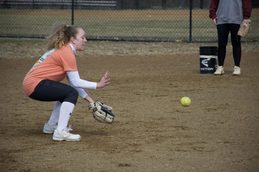 Junior Madison Thomas practices throwing at the voluntary off season practice. She gets into the correct ready position to field the ball at practice.