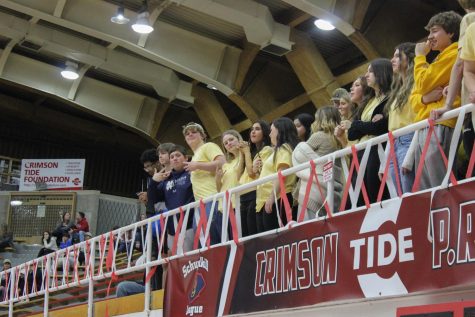 Students attended the gold out game to support their basketball team, show their school spirit, and support a good cause.