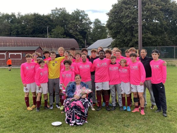 On October 9th, the boys soccer team stood behind Iris Nelson for a picture after giving her flowers and hugs to recognize her for her fight against breast cancer. The team also wore custom made shirts to show their support.