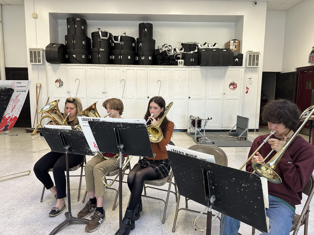 Mrs. Katelynn Reichard, Jake Powers (9), Makenzie Rebel (11), and Robert Rulavage (11), during their sectional. The four of them were practicing How the Grinch Stole Christmas for the bands concert. 