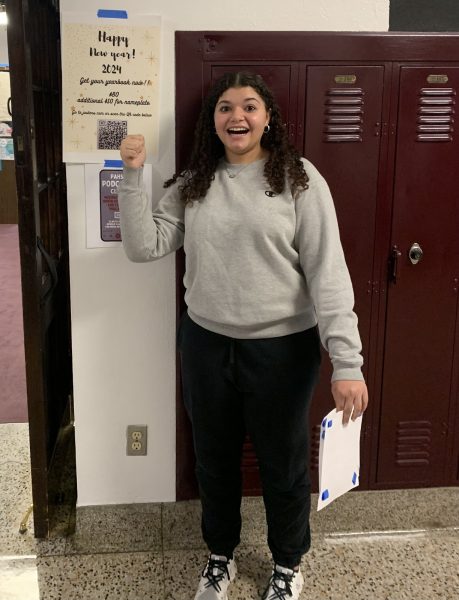 Pictured above is Kylie Morris standing next to a poster advertising the yearbook outside of the library. According to Kylie, buying a yearbook is definitely worth it and everyone should buy one.
