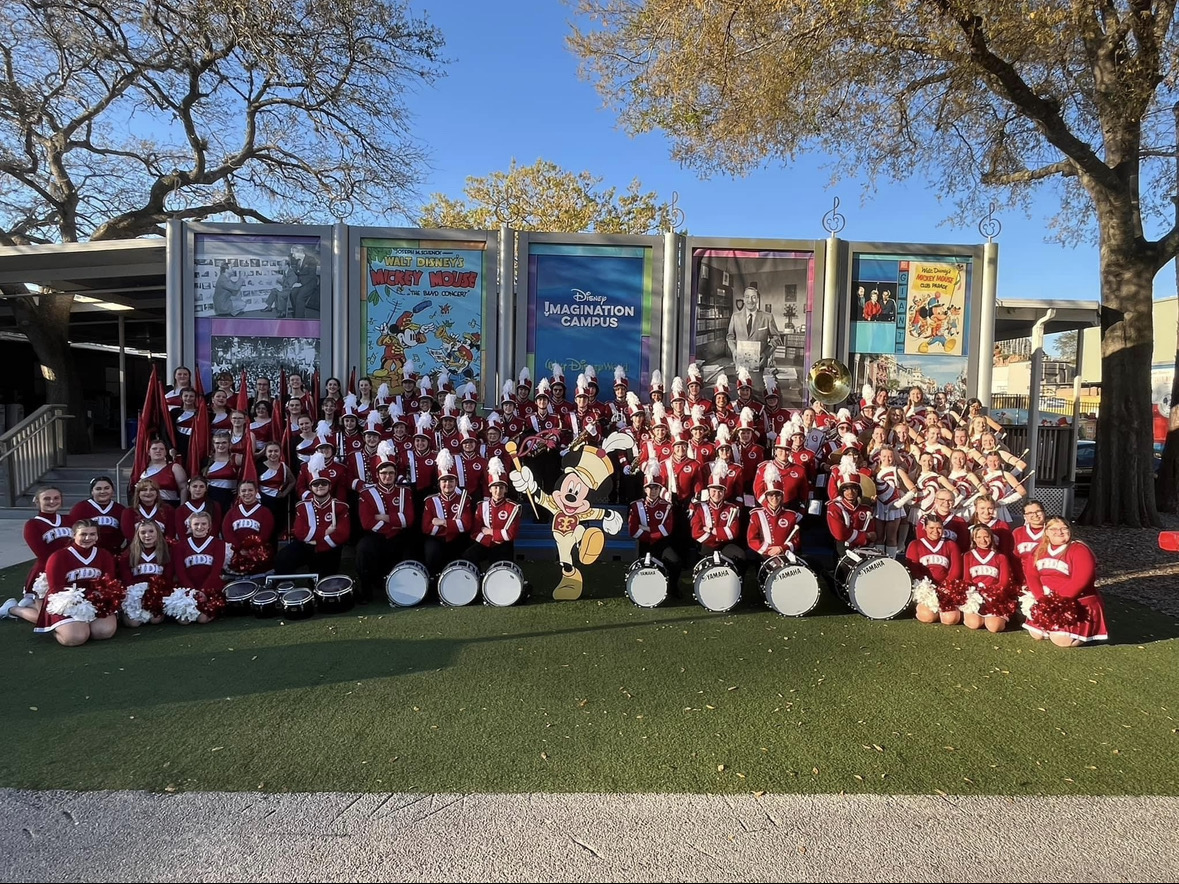 Here, the band is pictured before the parade in Magic Kingdom. Everyone is dressed in their respective uniforms ready for the parade. 