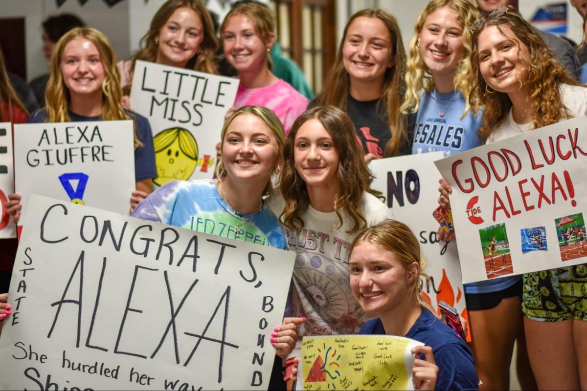 Students gather to wish Alexa Giuffre luck for her journey to States for track. “We were all super proud of Alexa and we just wanted to be there for her to show her our support and give her the best send off,” junior Julie Szeliga said. 