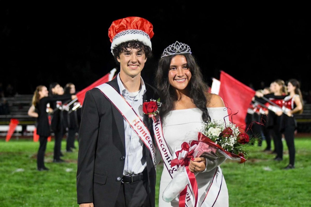 Seniors Cullen Clarke and Lauren Goodman are crowned Homecoming King and Queen. 2023 Queen and King Kali Hinkle and Parrish McFarland congratulates them. 